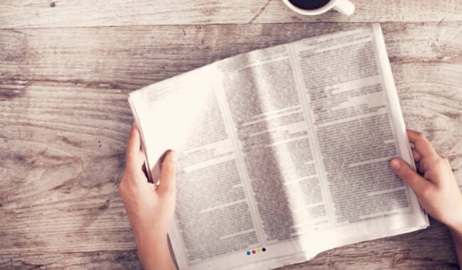 hands holding newspaper