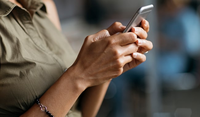 Woman typing on her mobile phone