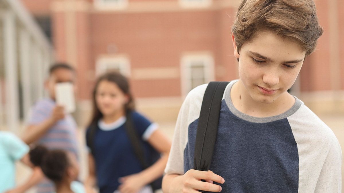 Kids bullying teen boy