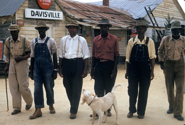 Men walking with a dog.