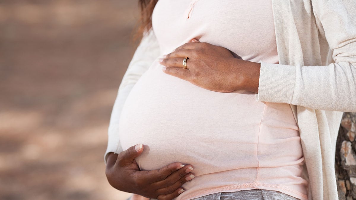 Person holding her belly.