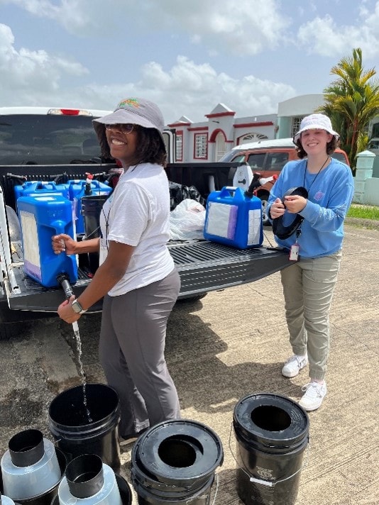 PHEFA participants fill mosquito traps with water for field research in Puerto Rico.