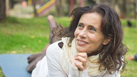 Woman outside lying on the ground