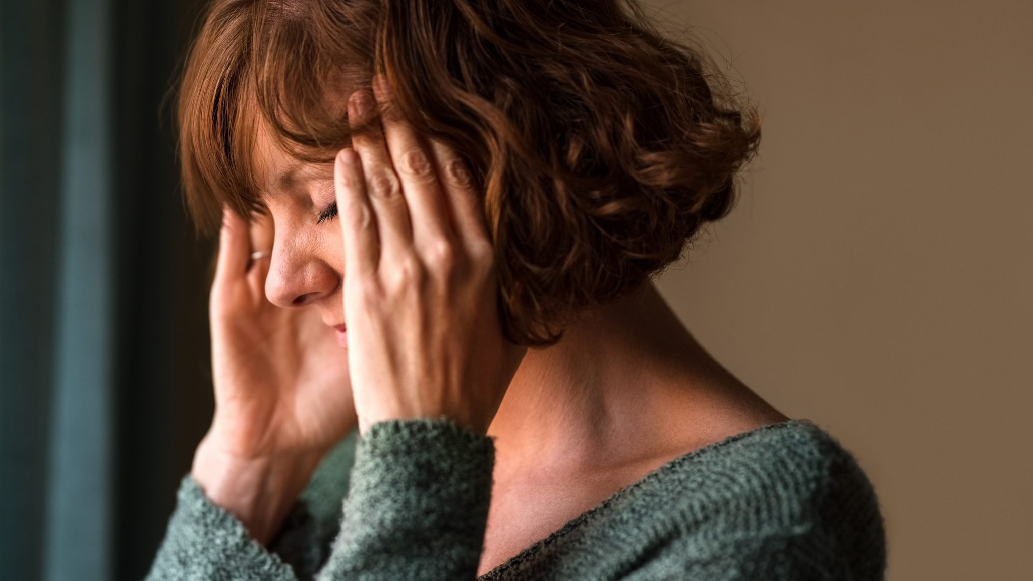 Woman holding her head in pain