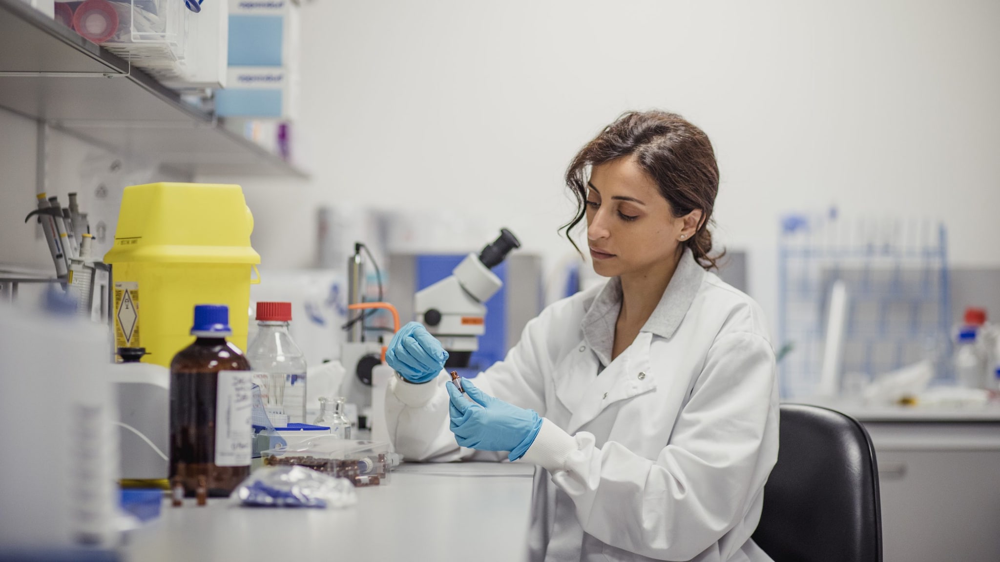 Lab worker at a microscope