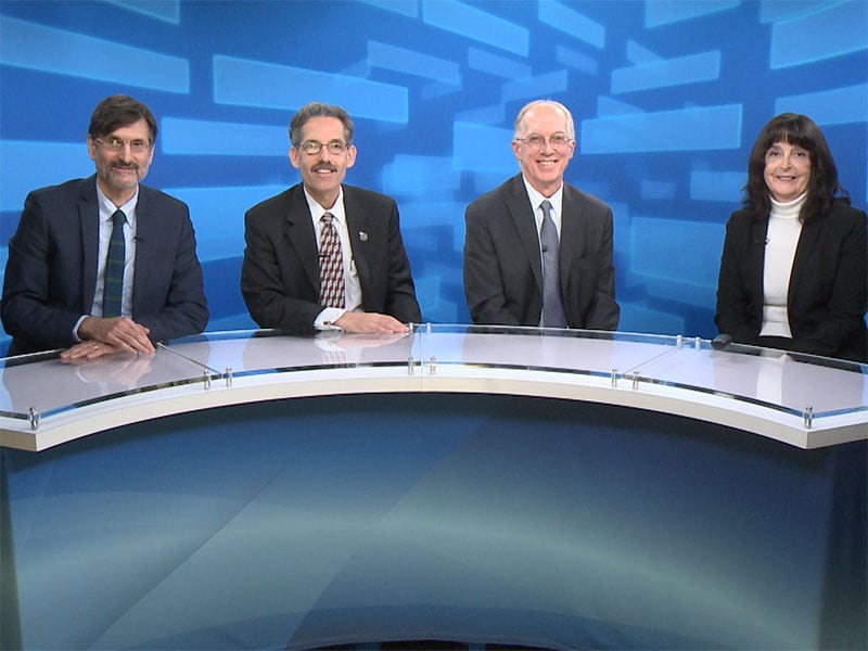 Dr. Farfel, Dr. Prezant, Dr. Crane, and Dr. Ward sitting around a semi-circular desk preparing to discuss Cancer and the World Trade Center Health Program